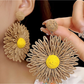 Side view of colorful raffia earrings showing detailed floral design