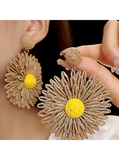 Side view of colorful raffia earrings showing detailed floral design