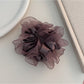 Ruffled scrunchie worn on the wrist as a stylish accessory
