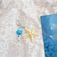 Starfish keychain held in hand to show scale and elegant craftsmanship
