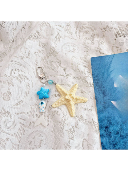 Starfish keychain held in hand to show scale and elegant craftsmanship