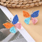 Model wearing Earedge butterfly shaped drop earrings with a black top