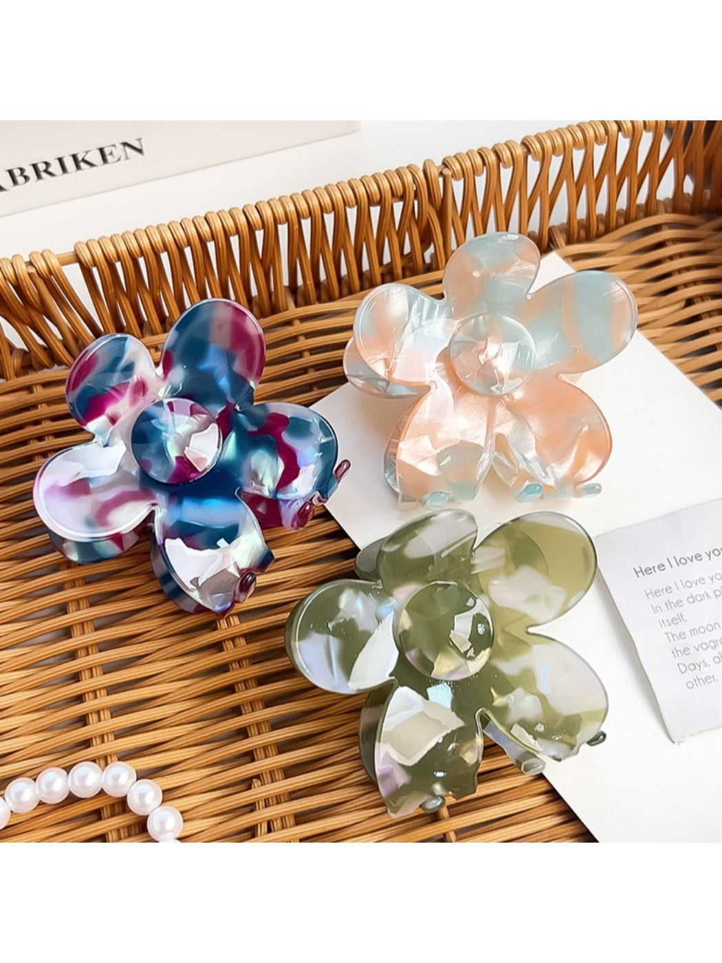 Side view of multicolored flower hair claw clip highlighting curved petals and grip