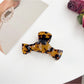 Model showing side profile with Beau bow shaped claw clip in hair