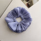 Gifty shimmer scrunchie styled in a ponytail with shiny layered fabric
