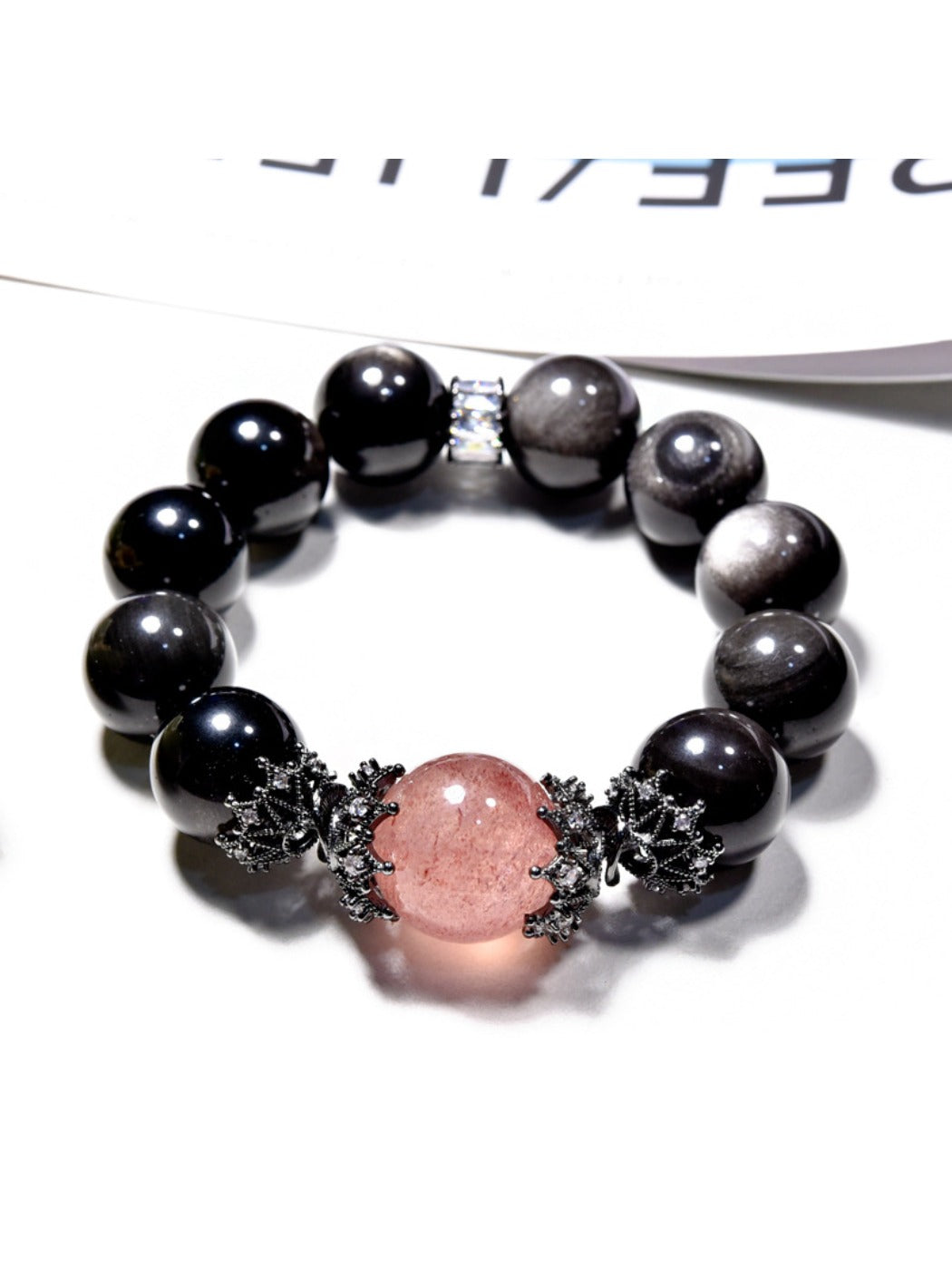 Close-up of Lovra minimalist black crystal beaded bracelet on a white background