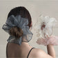 Gifty pleated scrunchie styled on a wrist as a chic accessory