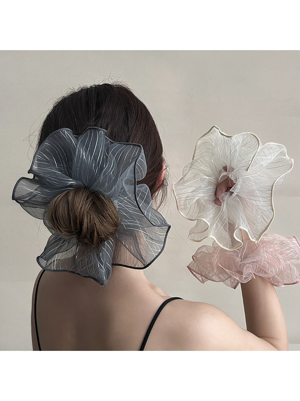 Gifty pleated scrunchie styled on a wrist as a chic accessory