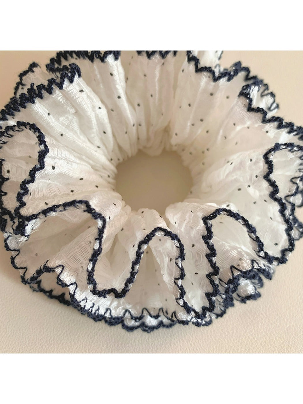 Side view of the Gifty sweet four tier ruffled scrunchie showing fabric texture