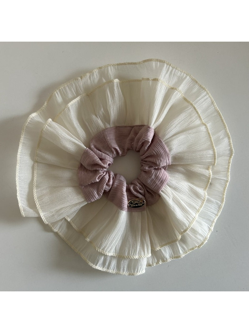 Close-up of lace fabric layers and stitching on the scrunchie