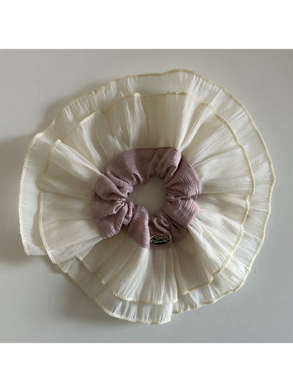 Close-up of lace fabric layers and stitching on the scrunchie