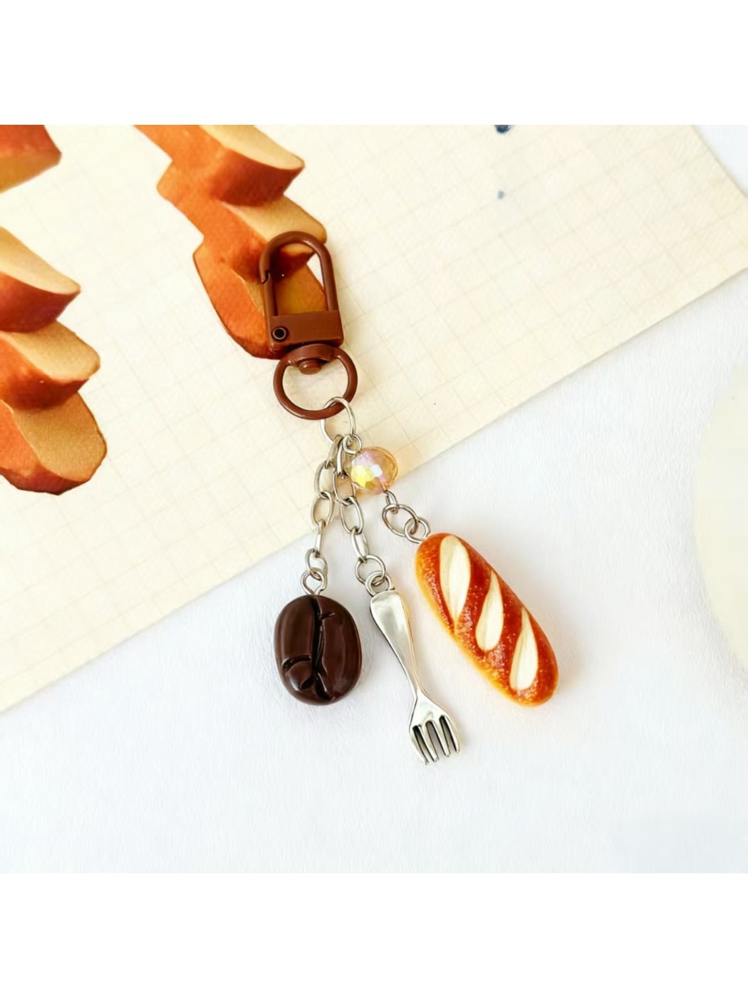 Mini baguette keychain displayed on a white background with soft shadows