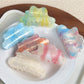Beau trendy cloud shaped hair claw clip in white on a plain background