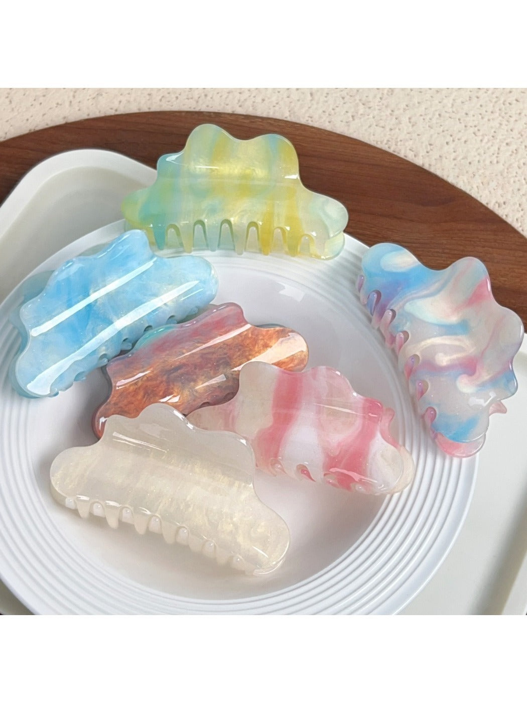 Beau trendy cloud shaped hair claw clip in white on a plain background