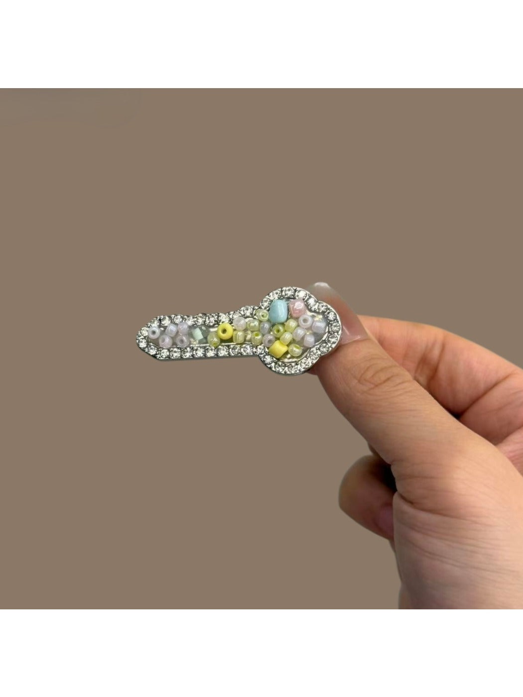 Beau key shaped hair clip displayed on a white background showing its key design