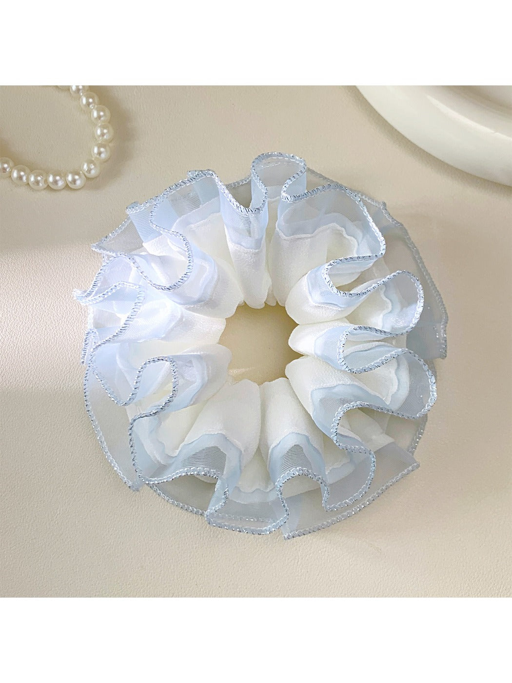 Gifty tulle ruffle scrunchie styled on a wrist with delicate ruffled texture
