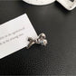 Beau classic bow hair clip held in hand showing size relative to fingers