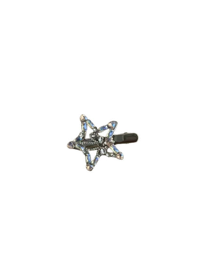 Beau hair clip shaped as a five point star adorned with rhinestones on a white background