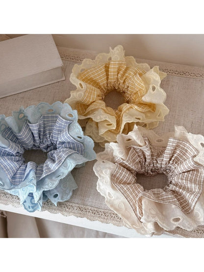 Close-up of Gifty lace scrunchie showing delicate floral lace texture in soft fabric