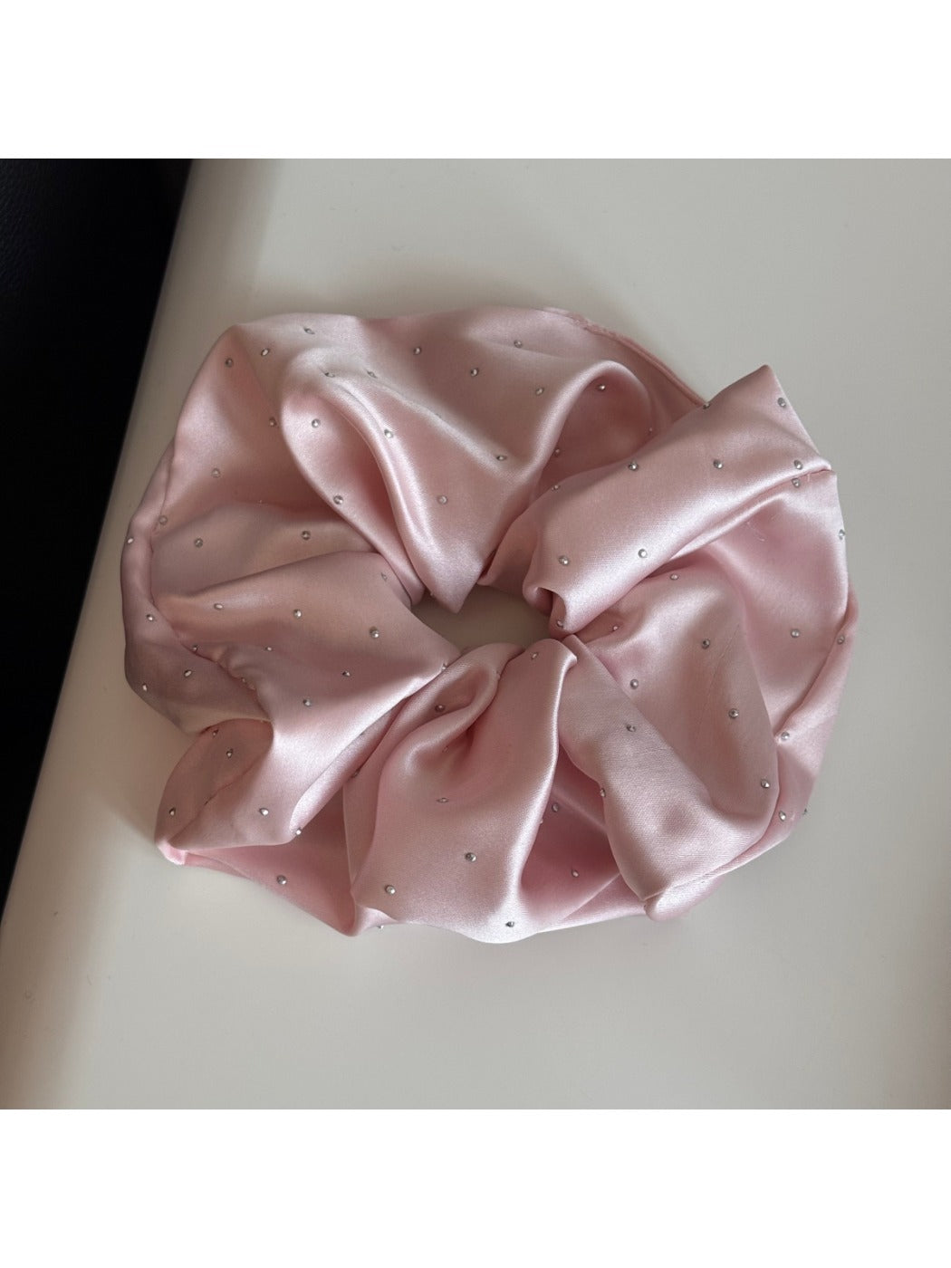 Gifty satin scrunchie with rhinestones shown in natural light highlighting texture