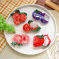 Close-up of orange slice fruit shaped hair clip showing detailed texture and colors
