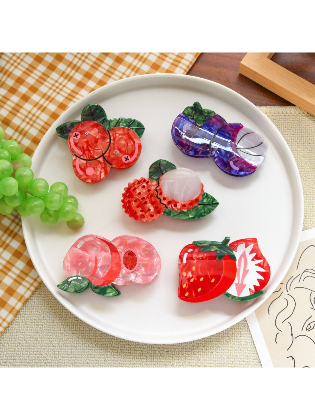 Close-up of orange slice fruit shaped hair clip showing detailed texture and colors