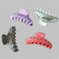 Side angle of Beau Irregular Polka Dot Claw Clip showing curved teeth