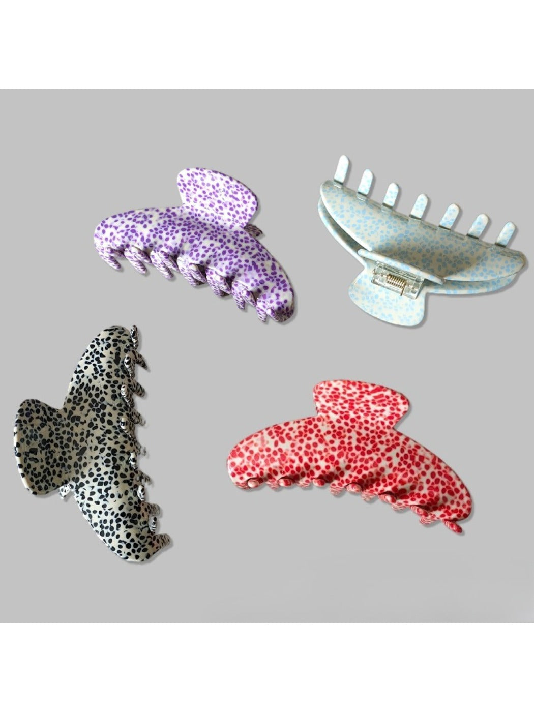 Side angle of Beau Irregular Polka Dot Claw Clip showing curved teeth