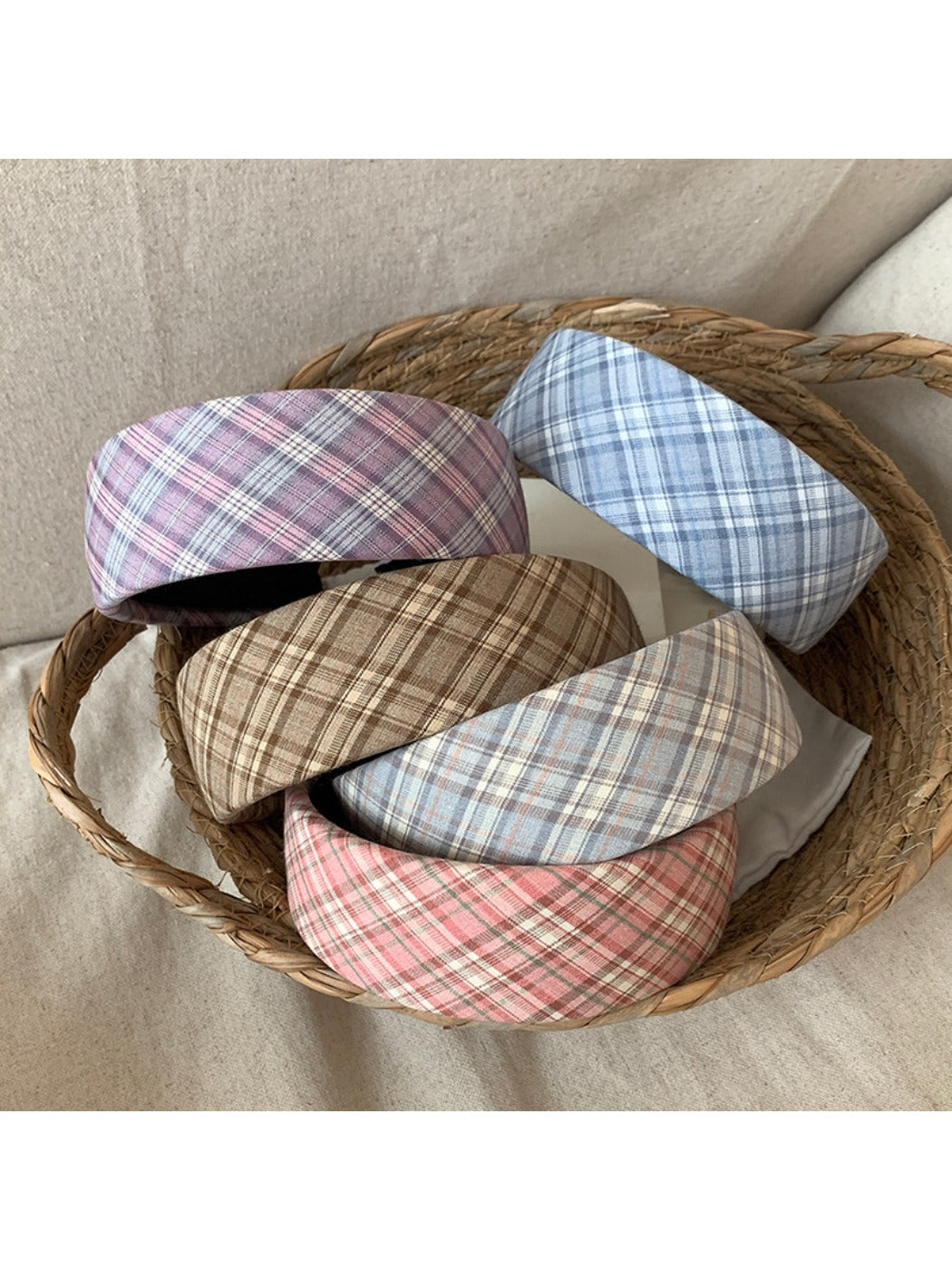 Wide plaid headband in beige and brown tones displayed on a white background