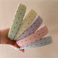 Close-up of Gifty headband showing multicolored polka dot pattern
