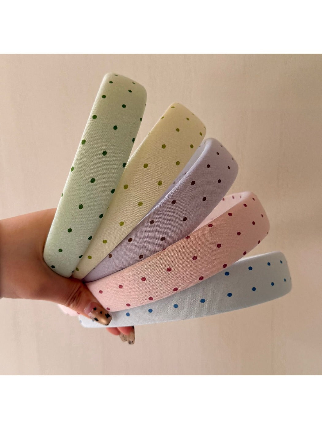 Close-up of Gifty headband showing multicolored polka dot pattern