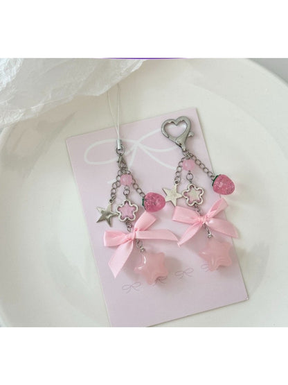 Pink star-shaped keychain with a bow attached to a silver keyring