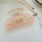 Back view of Beau semi circular hair claw clip in light beige color