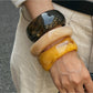 Side view of Lovra wide bangle bracelet highlighting its unique irregular design