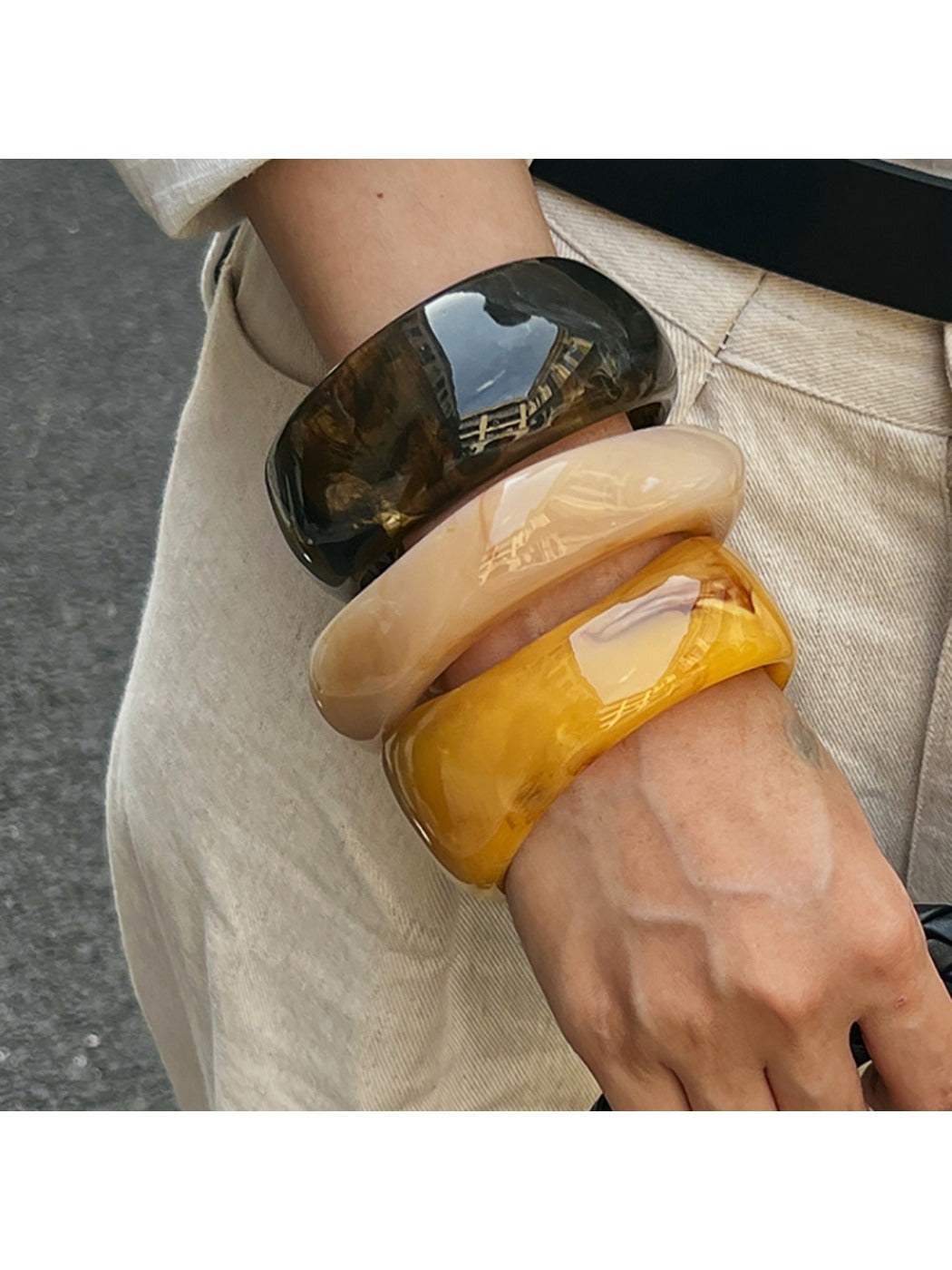 Side view of Lovra wide bangle bracelet highlighting its unique irregular design