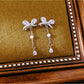 Earedge - Alloy Bow Stud Earrings with Drop Detail Earrings