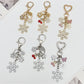 Close-up of delicate snowflake pendant keychain on a white background