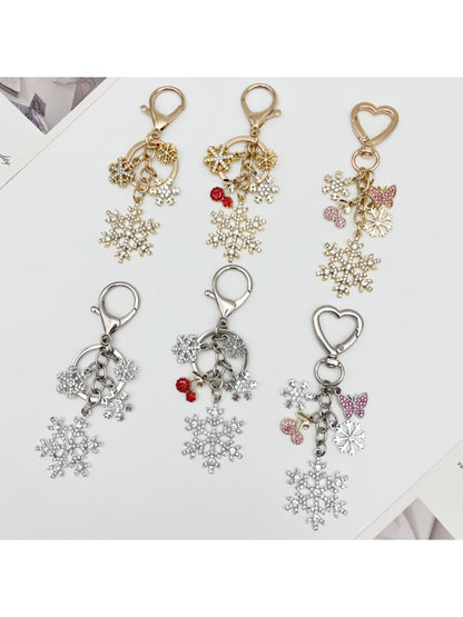 Close-up of delicate snowflake pendant keychain on a white background