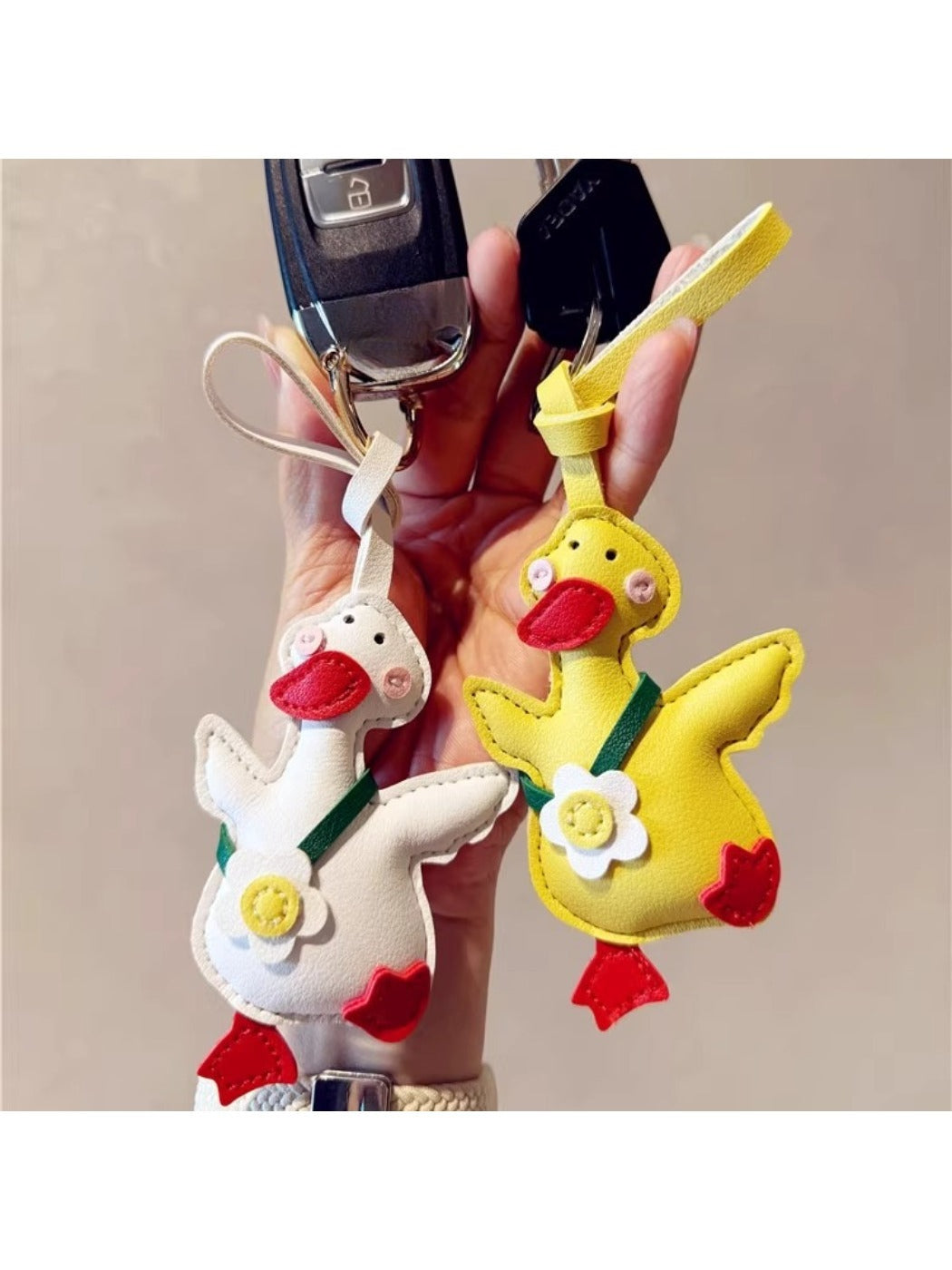 Yellow duck keychain hanging from a set of keys on a wooden surface
