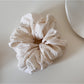 Gifty soft polka dot scrunchie styled on a wrist as a fashion accessory