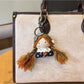 Vintage girl charm keychain shown attached to a backpack zipper pull for decoration