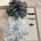Vintage style scrunchie with white polka dots on a muted pink fabric, ruched design