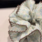 Gifty scrunchie styled on a wrist with vintage floral print