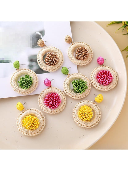 Close-up of Earedge creative raffia woven earrings with intricate natural fiber design