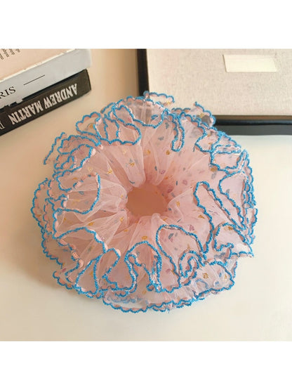 Pink scrunchie with multiple ruffled layers on a white background