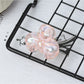 Beau small butterfly claw clip in natural light highlighting soft pink color