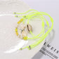 Side view of Lovra alloy mermaid tail bracelet with small round beads