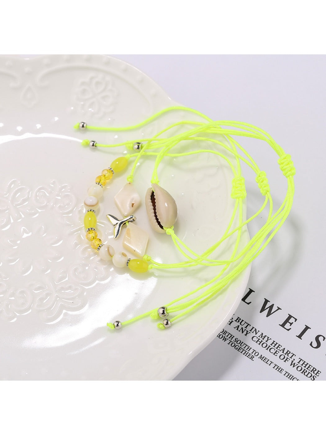 Side view of Lovra alloy mermaid tail bracelet with small round beads