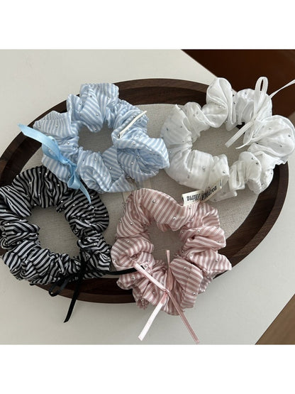 Close-up of Gifty Sweet Bow Stripe Scrunchie with pink and white stripes on a white background
