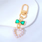 Beaded heart keychain lying flat with a shadow on a light surface
